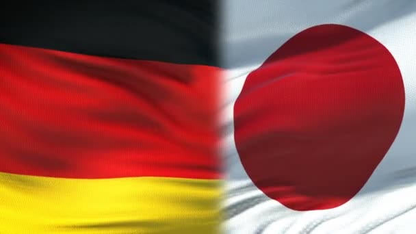 Рукопожатие Германии и Японии, отношения международной дружбы, фон флага — стоковое видео