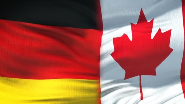 Deutschland und Kanada Händedruck, internationale Freundschaftsbeziehungen Flagge Hintergrund — Stockvideo