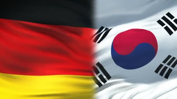 Deutschland und Südkorea Händedruck, internationale Freundschaft, Fahnenhintergrund — Stockvideo