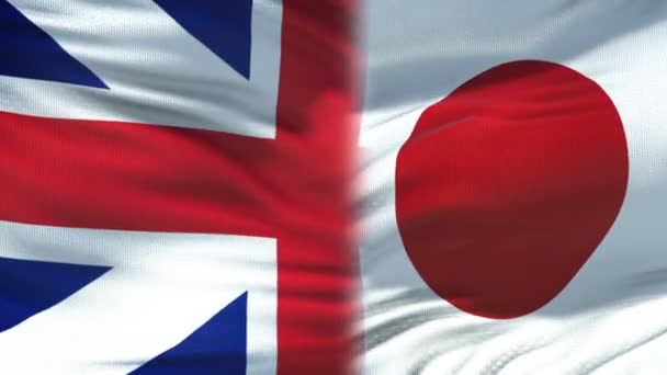 Forenede Kongerige og Japan håndtryk, internationalt venskab, flag baggrund – Stock-video