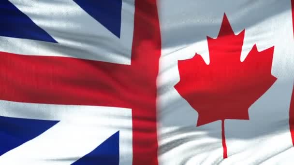 Nagy-Britannia és Kanada kézfogás, nemzetközi barátság, zászló a háttérben — Stock videók