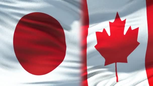 Japón y Canadá apretón de manos, relaciones de amistad internacional, fondo de la bandera — Vídeo de stock