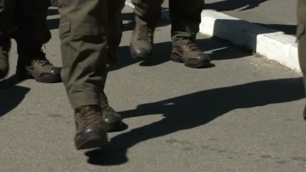 Squad of men in uniforms walking along street, changing guard at state border — Stock Video