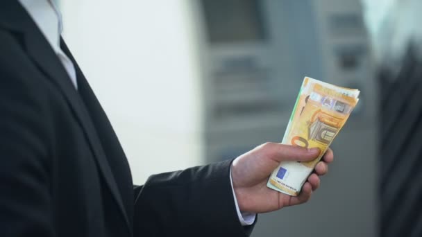 Бизнесмен считает евро, которые он хочет отправить семье, быстрые денежные переводы — стоковое видео
