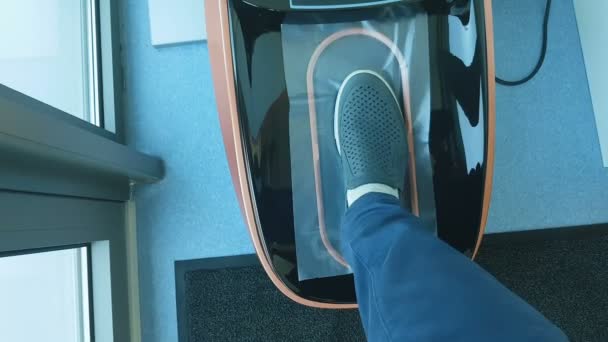 Automatic shoe cover dispenser in operation, sterility, hygiene in hospital — Stock Video