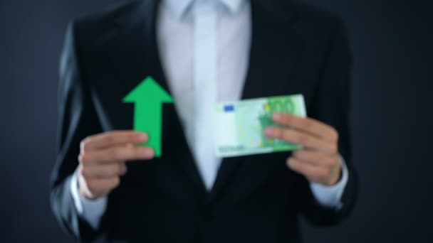 Επιχειρηματίας δείχνει τραπεζογραμματίου ευρώ και πράσινο βέλος σύμβολο, νόμισμα που αυξάνεται, έσοδα — Αρχείο Βίντεο