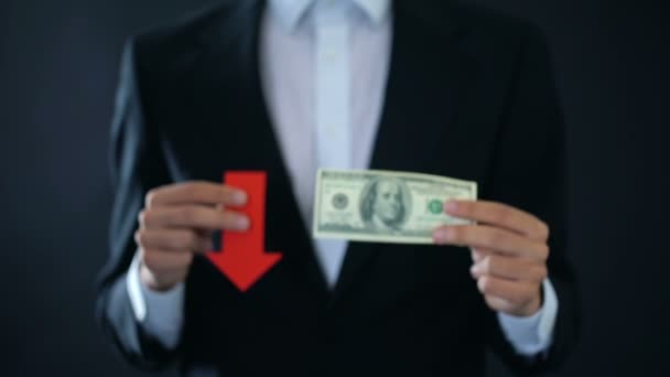 Businessman showing dollar banknote and red arrow sign falling, financial crisis — Stock Video