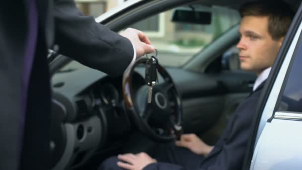 Exitoso hombre de negocios sentado en el asiento del conductor, tomando las llaves del coche acaba de comprar — Vídeo de stock