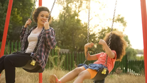 Niñera Joven Jugando Con Niño Despreocupado Balanceándose Aire Libre Parque —  Fotos de Stock