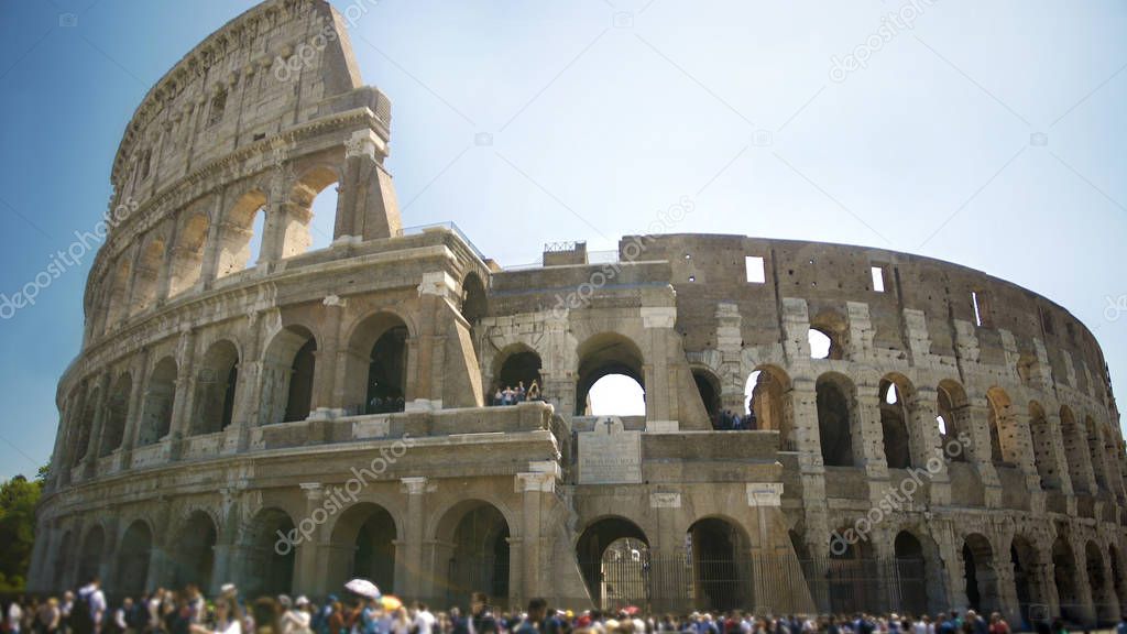 Coliseum ancient amphitheater in Rome, Italy, tourists enjoying summer tour