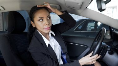 Successful lady boss smartening hairstyle up, looking into car mirror, beauty clipart