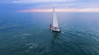 Boat sailing in ocean with couple standing at bow, future opportunities, freedom clipart