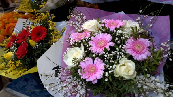 Colorful bouquets of flowers presented in shopping mall, floristics business