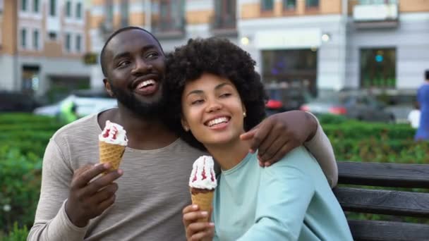 快乐的男朋友和女朋友在长凳上笑 浪漫的约会与冰淇淋 — 图库视频影像