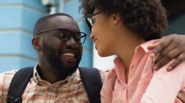 Gençlerin kucaklayan ve hayatın tadını çıkarırken merdivenlerde, oturan mutlu portre