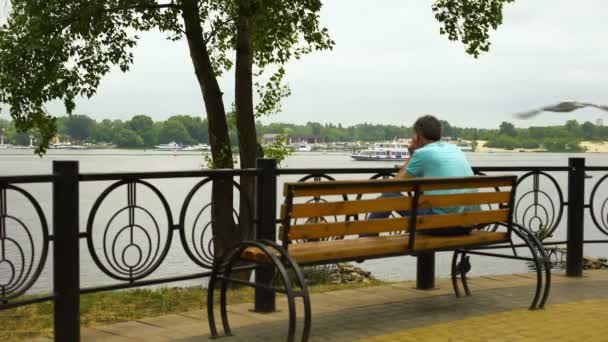 Male Sitting City Bench Enjoying River View Park Pleasure Boat — Stock Video