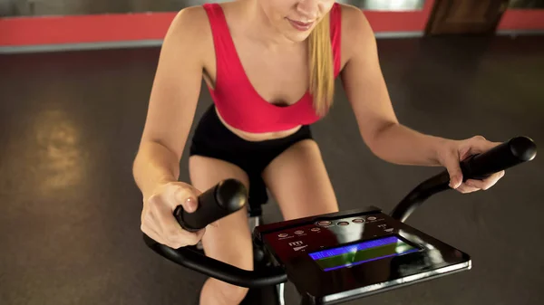 Athletic Woman Riding Stationary Bike Looking Electronic Panel Sport — Stock Photo, Image