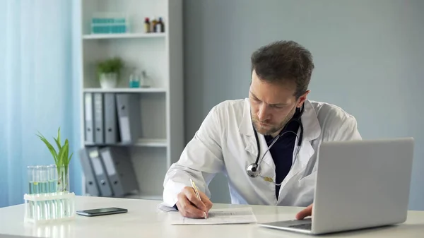 Doctor Viewing Test Results Laptop Writing Medical Records Medicine — Stock Photo, Image