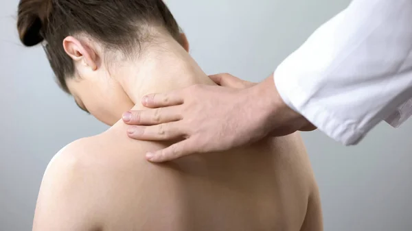 Neurologist touching female shoulders, doctor examining spine, healthcare — Stock Image Neurologist Touching Female Shoulders Doctor Examining Spine Healthcare Royalty Free Stock Images