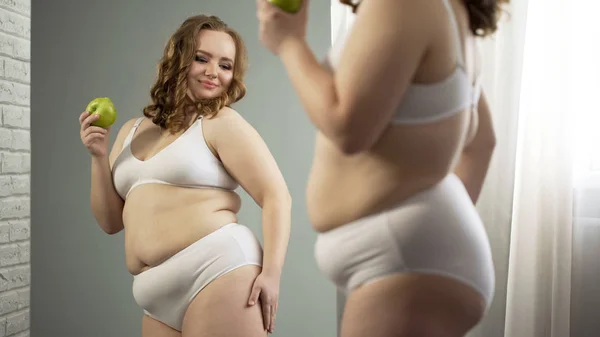 Krullend Mollig Meisje Eten Apple Voor Spiegel Blij Met Het — Stockfoto