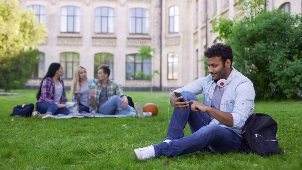 Spaanse Mannelijke Student Zittend Gras Het Gebruik Van Mobiel App — Stockfoto