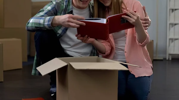 Couple Watching Photo Album Moving Together Unpacking Boxes Stuff — Stock Photo, Image