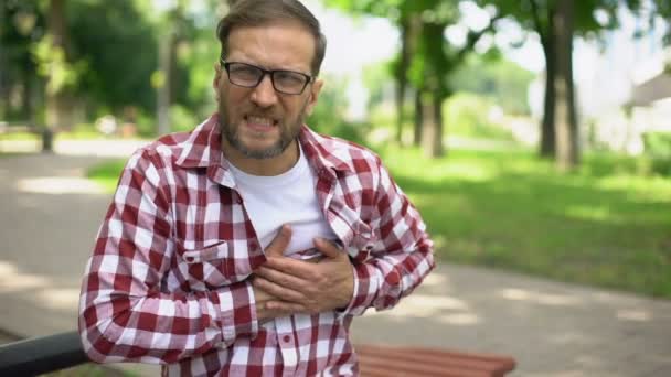 Male Feeling Chest Pain Sitting Outdoors Heart Arrhythmia Ischemic Disease — Stock Video