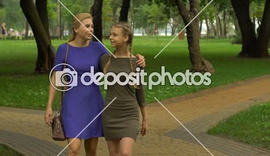 Mutlu anne ile kızı park, dostluk, güven ve aile birlik içinde yürüyüş