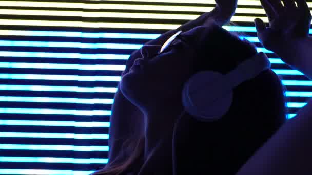 Jovem Mulher Fones Ouvido Fundo Iluminado Entretenimento Urbano Relaxar — Vídeo de Stock