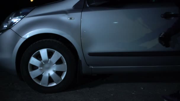 Young Criminal Taking Car Wheel Night Hooligan Damaging Property — Stock Video