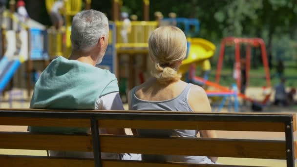 Retired Man Woman Bench Park Watching Grandchildren Happy Memories — Stock Video