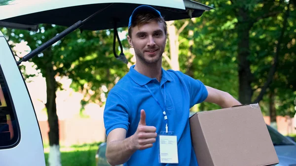Young Delivery Man Holding Parcel Showing Thumbs Fast Shipping Service — Stock Photo, Image