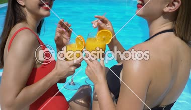 Havuz kenarında eğleniyor ve kokteyller, yaz havuz partisi içme iki kadın