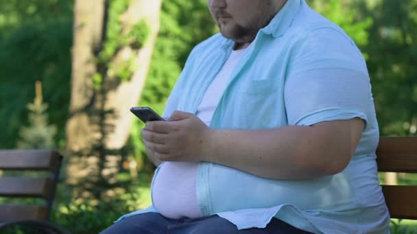 体重について安全でないネットワークで友達を探して若い肥満男 — ストック動画