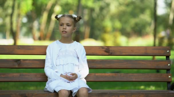 Cute Schoolgirl Sitting Alone Bench Park Looking Lack Friends — Stock Video