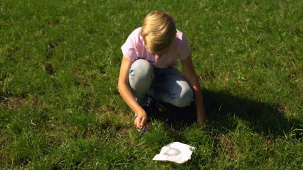 Boy Trying Make Fire Magnifier Paper Tips Surviving Forest — Stock Video