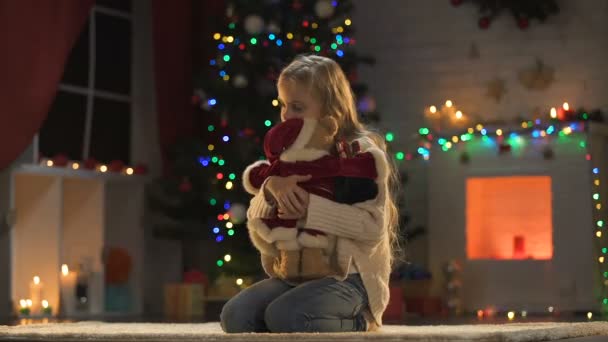 Einsames Süßes Mädchen Sitzt Neben Funkelndem Weihnachtsbaum Und Girlanden Vermisste — Stockvideo