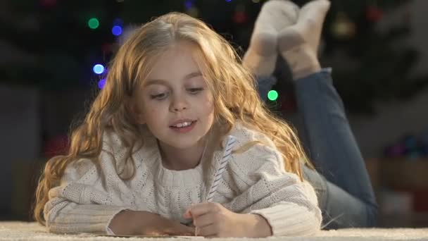 Excited Girl Writing Letter Santa Claus Dreaming Gifts Pile Childhood — Stock Video