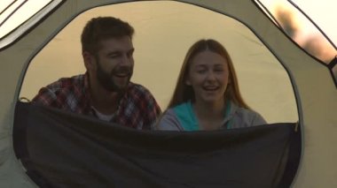 Gülümseyen kadın ve aşk adam kameraya göz kırpıyor ve yapacak bir çadır kapanış