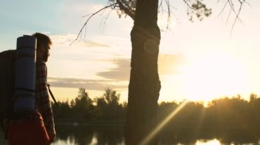 Ormanda, seyahat trekking genç erkek backpacker günbatımı yakın göl, zevk
