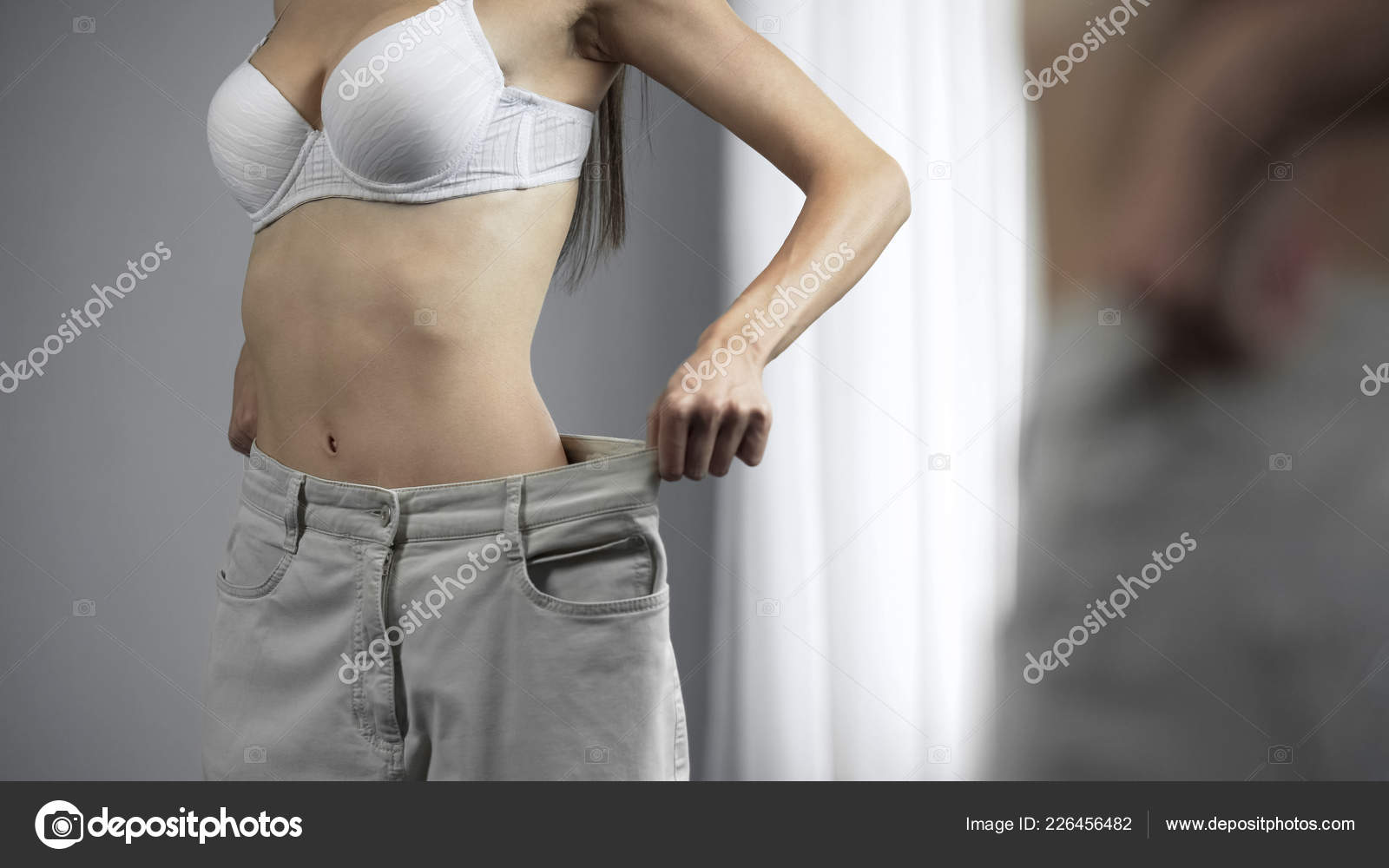 Slim Figure Woman Wearing Big Pants Posing Front Mirror Weight Stock Photo  by ©motortion 226456482