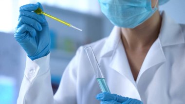 Laboratuar işçisi damlama sarı sıvı test tüp, petrol kalite kontrol, deney