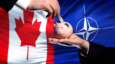 Canada investment in NATO, hand putting money in piggybank on flag background clipart