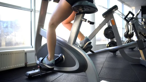 Womans Legs Training Stationary Bike Burning Calories Cardio Exercise — Stock Photo, Image