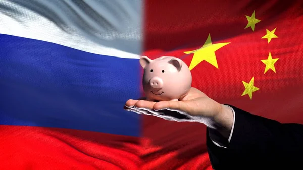 Russia Investment China Businessman Hand Holding Piggybank Flag Background — Stock Photo, Image