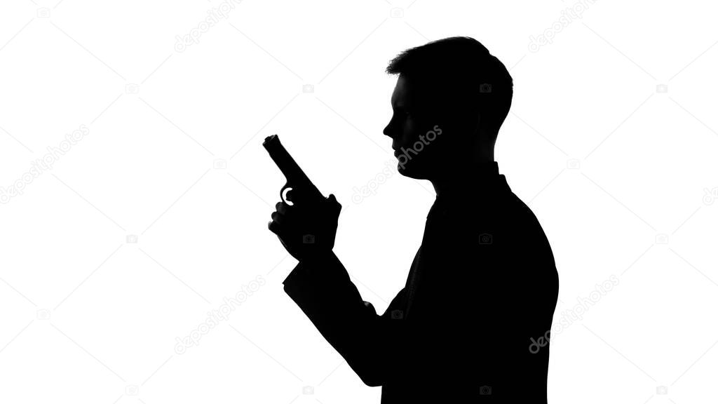 Male silhouette holding gun, preparing to shoot, revenge, contract killing