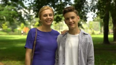 Neşeli oğlu ve sarılma anne başparmak-up, gösterilen eğlence birlikte zevk