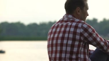 Nehir banka düşünme hakkında hayat adaletsizlik, orta yaş krizi üzerine oturan boşanmış adam