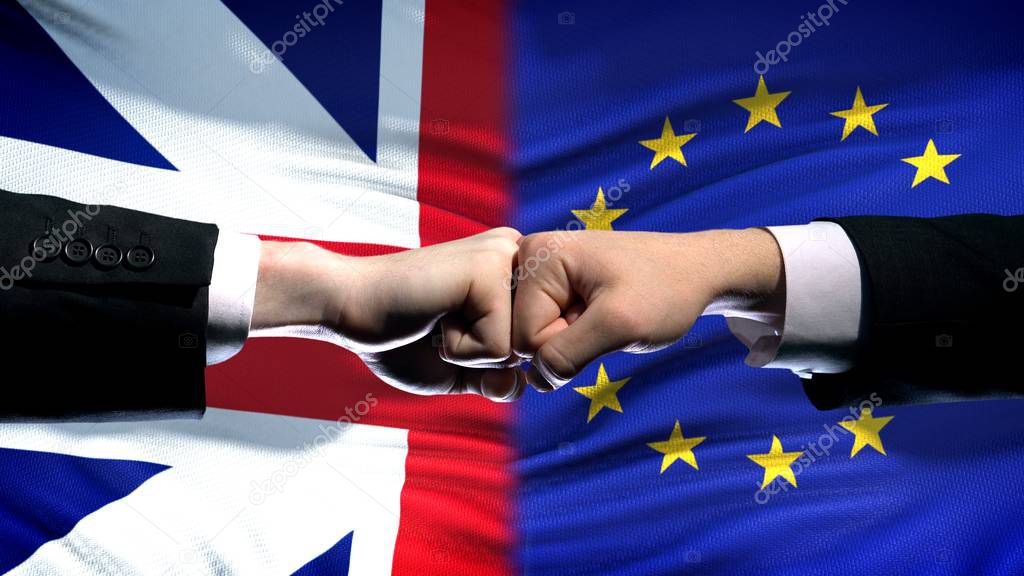 Great Britain vs EU conflict, international relations, fists on flag background