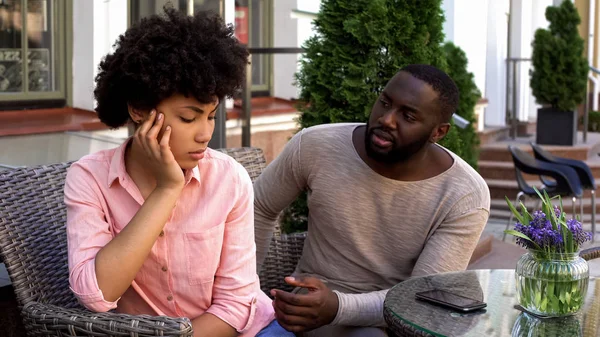 Sad offended lady ignoring boyfriend, turned away, misunderstanding, conflict